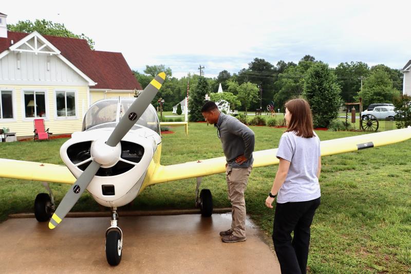 Kent Milligan, left, and Courtney Bayley, both students in the aviation program at Del Tech, check out John Chirtea’s 1965 Aircoupe.